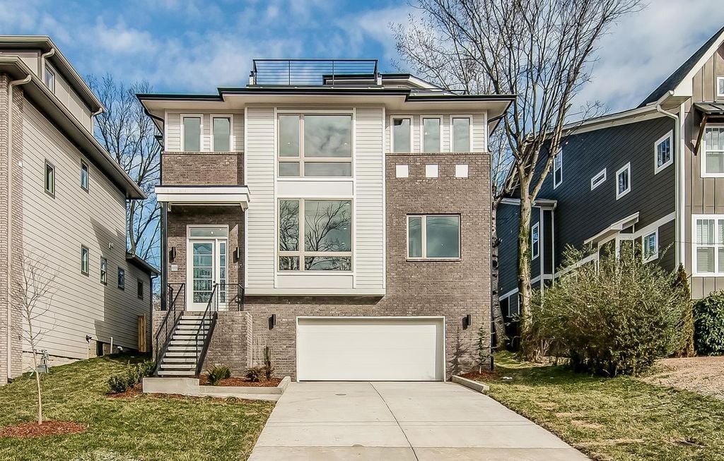 Exterior of 1006 Waverly Ave Nashville TN, a three-story modern new construction home by Province Builders in the Belmont Waverly neighborhood, featuring brick facade, rooftop deck, and attached garage, listed by BDG Partners at Compass