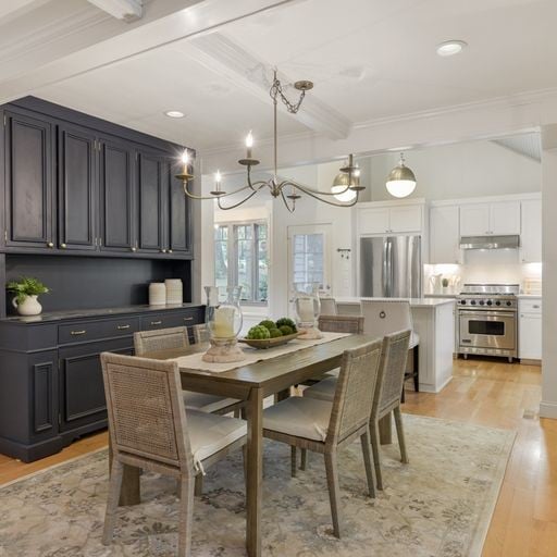 Kitchen and dining area inside a Green Hills Nashville home in 37215 with dark cabinetry and coffered ceiling