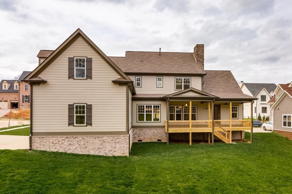 Rear exterior of a Ladd Park home in Franklin TN showing screened porch, deck, and spacious backyard