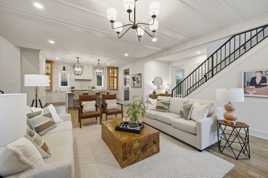 Open floor plan great room with coffered ceiling, white oak floors, and chef's kitchen in new construction 12 South Nashville home