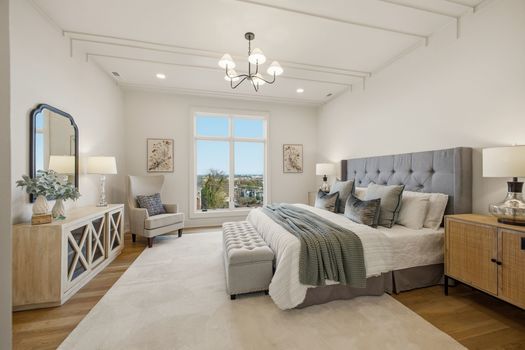 Primary bedroom suite with coffered ceiling, view window, and hardwood floors in luxury new construction home at 2113 Eastwood Ave Nashville