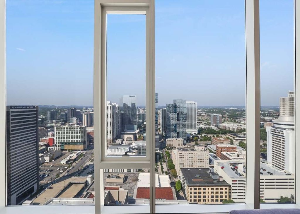 Aerial view of Nashville skyline through floor-to-ceiling windows of a downtown high-rise condo