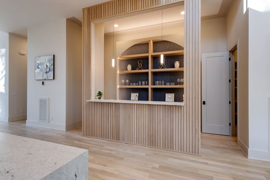 Custom wet bar with fluted White Oak millwork at 720 Adkisson Ln, Nashville 37205