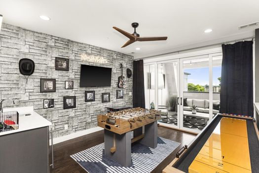 NASHVEGAS-themed game room with foosball, shuffleboard and a private balcony at 1013 Rev Dr Enoch Jones Blvd #10, a short-term-rental townhome in North Nashville