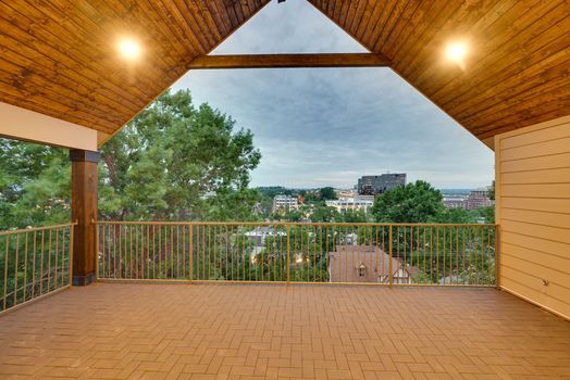 Covered third-floor balcony with vaulted pine tongue and groove ceiling and Nashville skyline views at 3304 Love Cir in West End