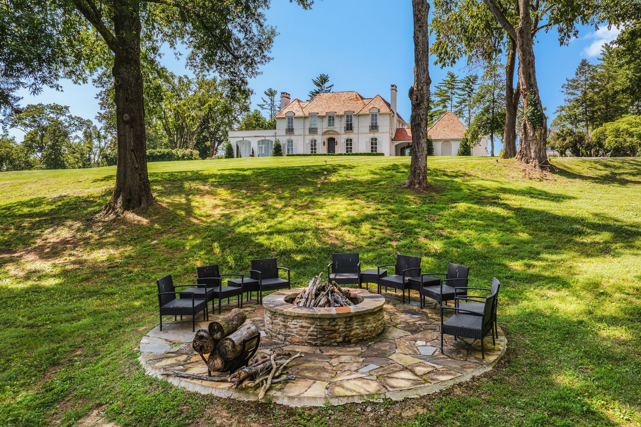 Stone fire-pit terrace at the water's edge on the grounds of 4753 Post Road, Nashville