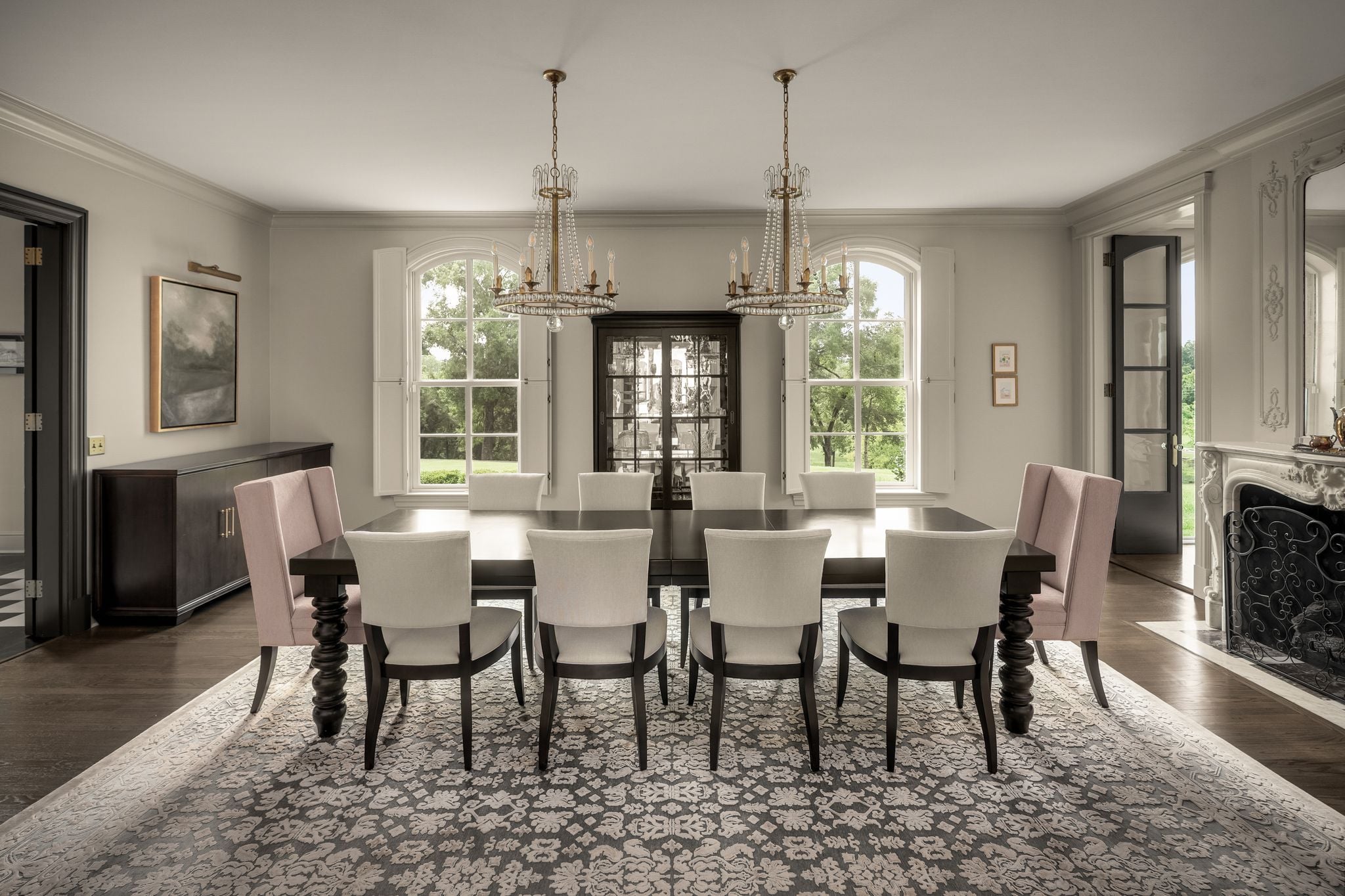 Formal dining room with double crystal chandeliers and original marble fireplace at 4753 Post Road, Nashville