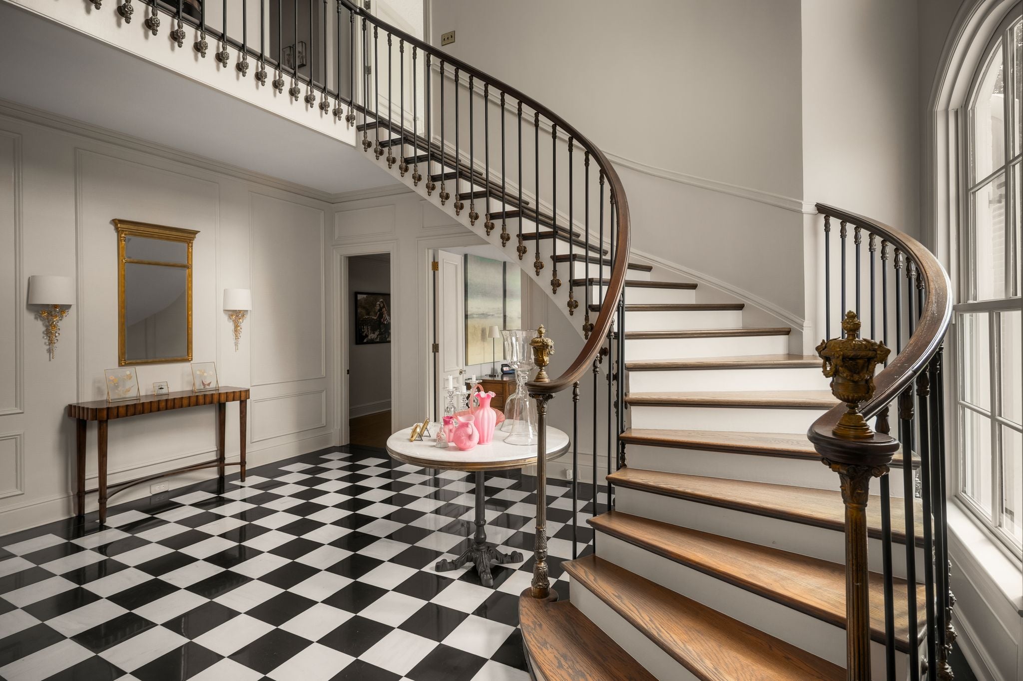 Original black-and-white marble foyer floor and curved iron staircase at 4753 Post Road, Hillwood Nashville