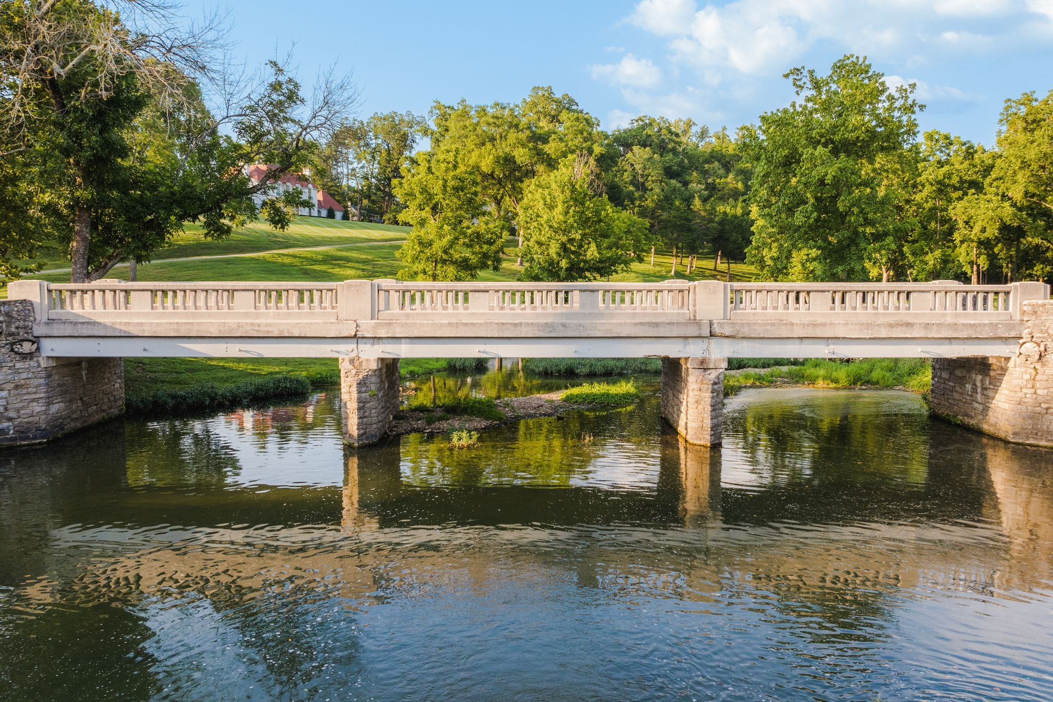 Historic stone bridge reflected in Richland Creek at 4753 Post Road, Hillwood, Nashville