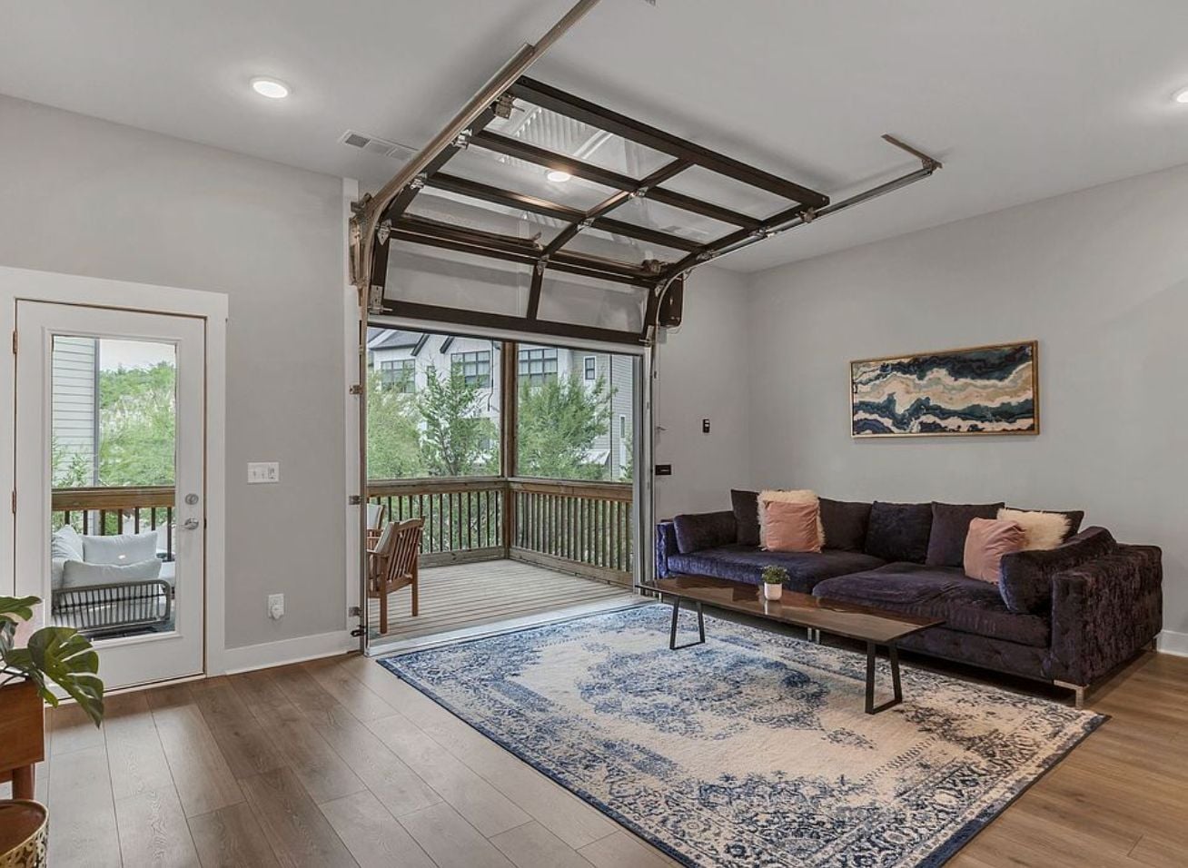 Living room at 204 Stonecrest Circle in Bellevue with a glass garage-style door opening to the covered deck