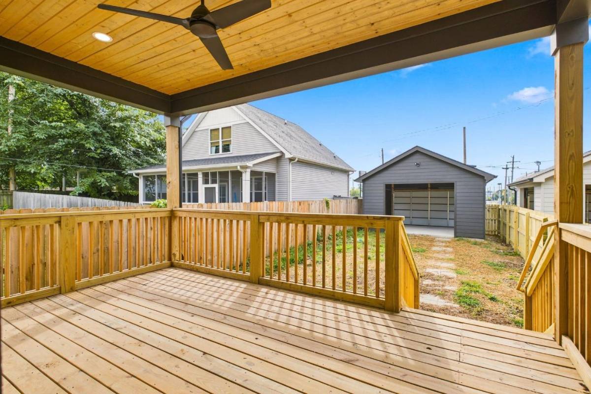 Covered rear porch overlooking the fenced yard and detached garageport at 2915A Davis Avenue