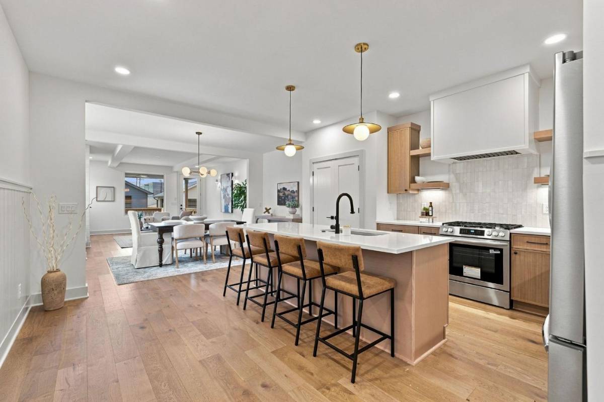 Kitchen at 2915A Davis Avenue with a long gathering island, bar seating and pendant lights