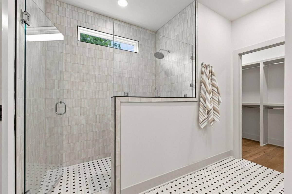 Primary bathroom walk-in tiled shower with glass enclosure at 2915A Davis Avenue