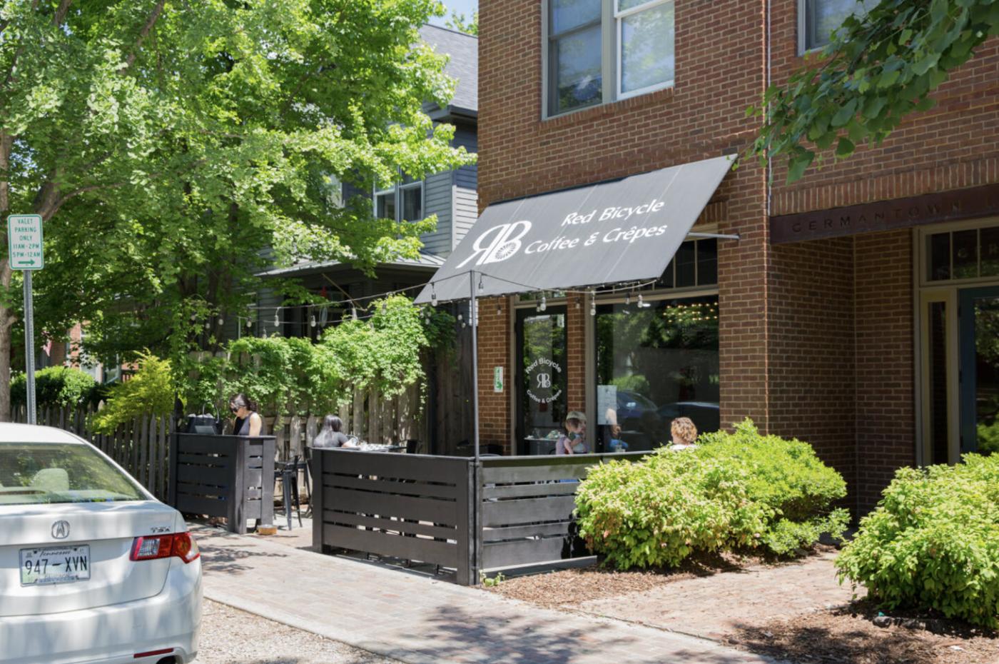 Red Bicycle Coffee and Crepes storefront with sidewalk patio on the ground floor of 1200 5th Avenue North in Historic Germantown Nashville