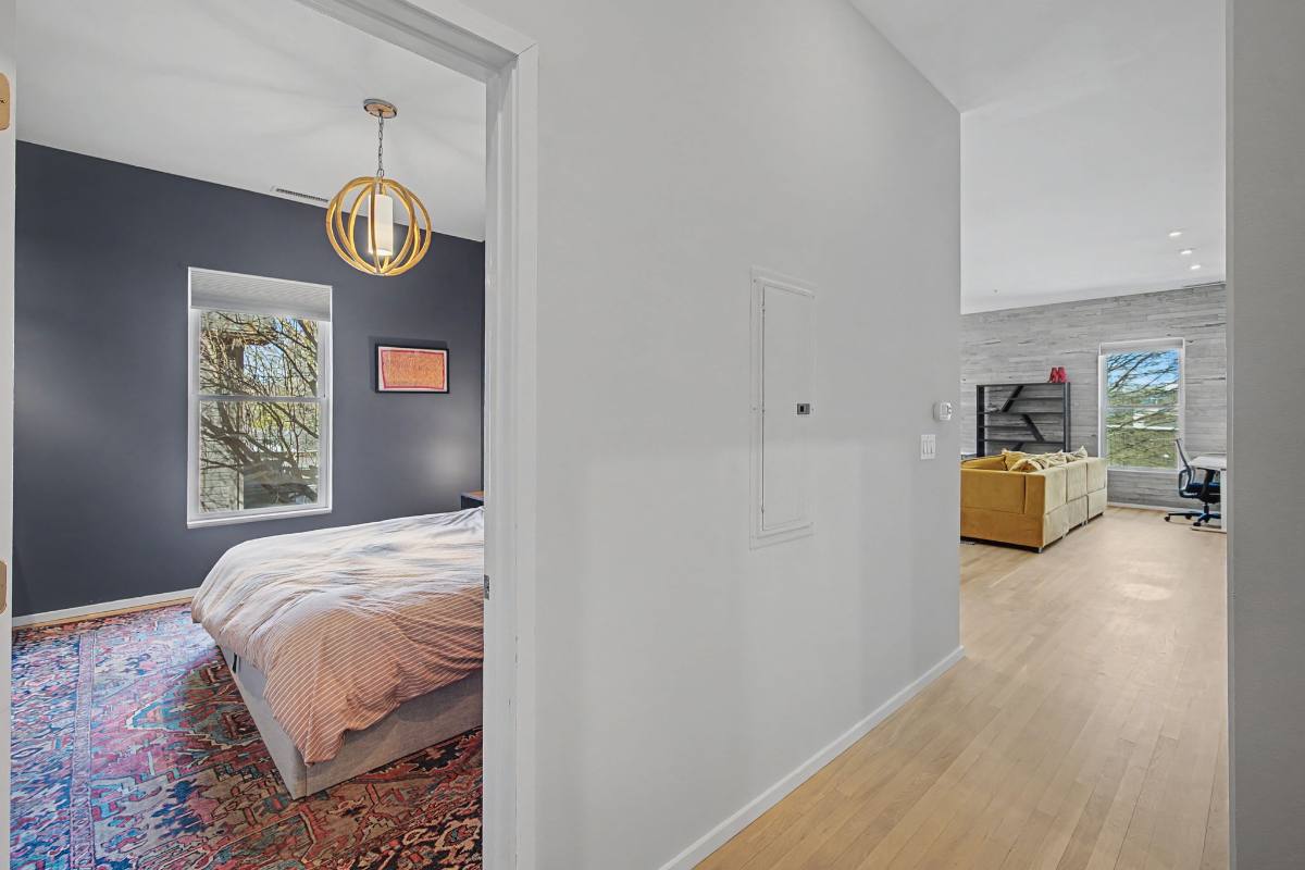 View from the hallway into the bedroom at Residence 414, 1200 5th Avenue North, with the living area beyond
