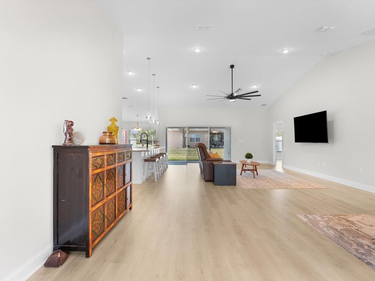 A welcoming entryway in a Palm Coast home featuring elegant glass doors leading to the dining and living rooms.
