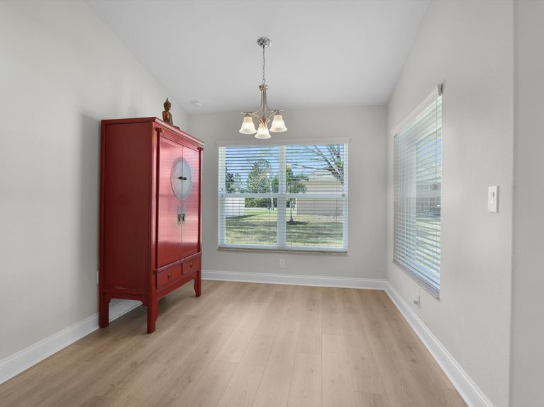 A bright eat-in kitchen space in a Palm Coast home featuring a dining nook with seating and a view of the backyard.