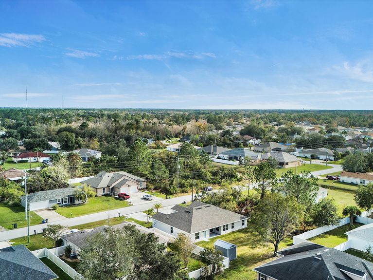 A quiet and picturesque neighborhood in Palm Coast, Florida, featuring tree-lined streets, well-maintained homes, and spacious lots with no HOA or CDD fees.