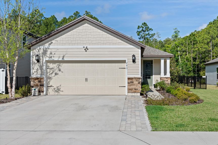 Front exterior view of a stylish home with well-maintained landscaping and inviting curb appeal.