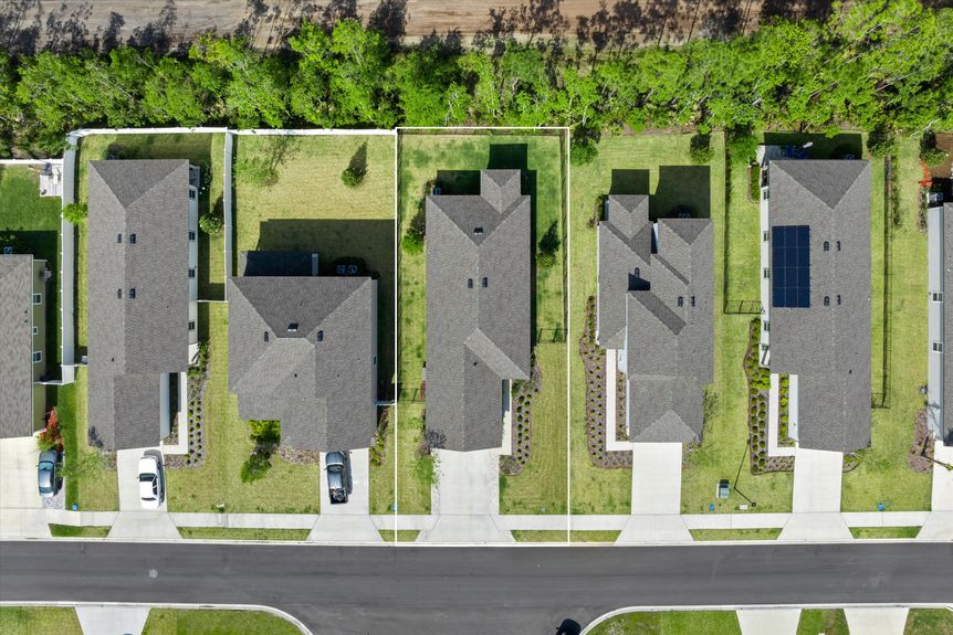 Aerial view of a beautiful home, showing the surrounding property and neighborhood.