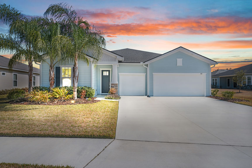 Beautiful one-story home at 50 Skyline Lane in St. Augustine’s 55+ community, featuring a well-manicured lawn, inviting front porch, and modern architectural design.