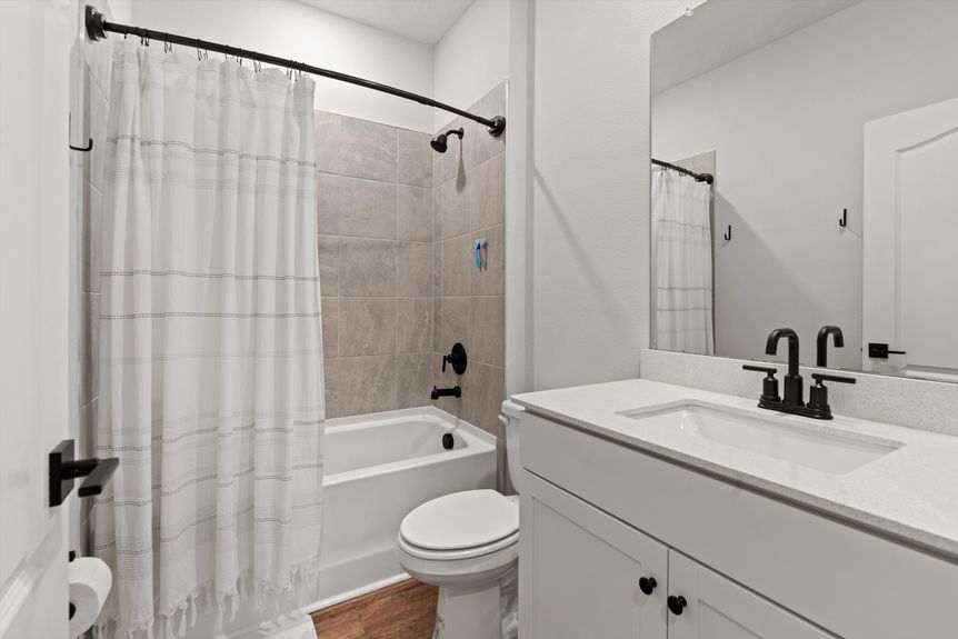 Guest bathroom featuring elegant fixtures, a vanity, and a walk-in shower.