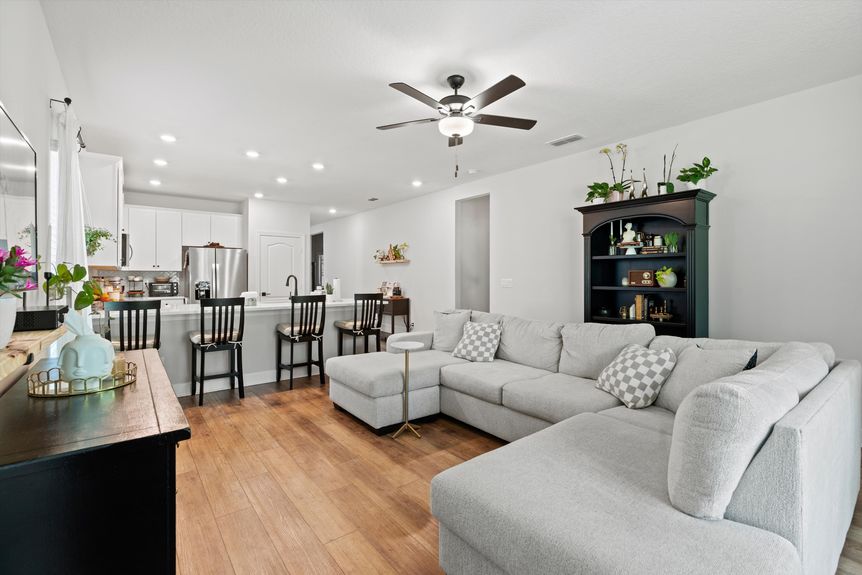 Spacious living room with large windows, cozy seating, and modern design in a St. Augustine home.