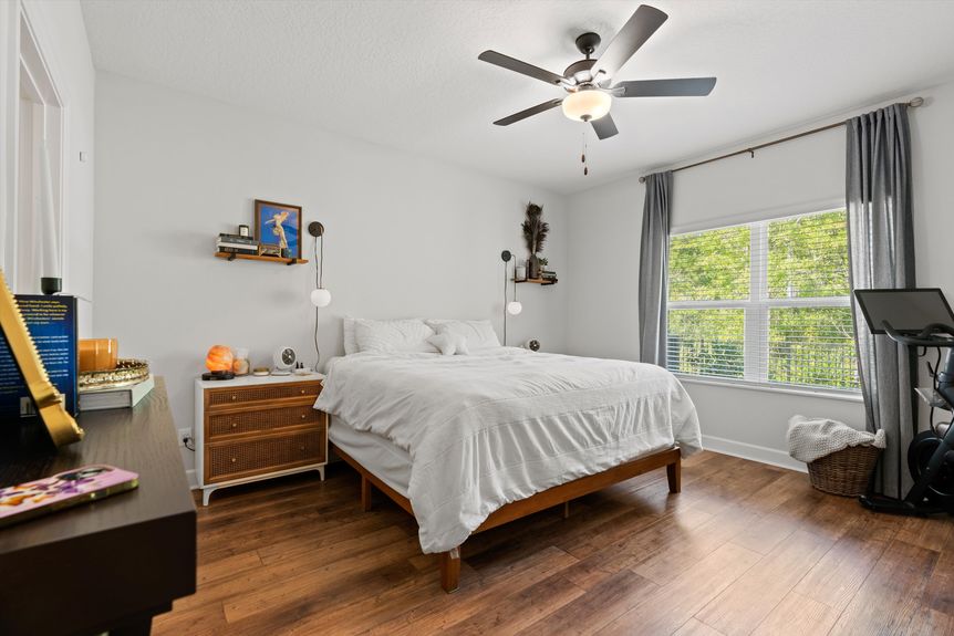 Spacious primary bedroom with large windows, neutral tones, and an ensuite bathroom in a Morgan Cove home.
