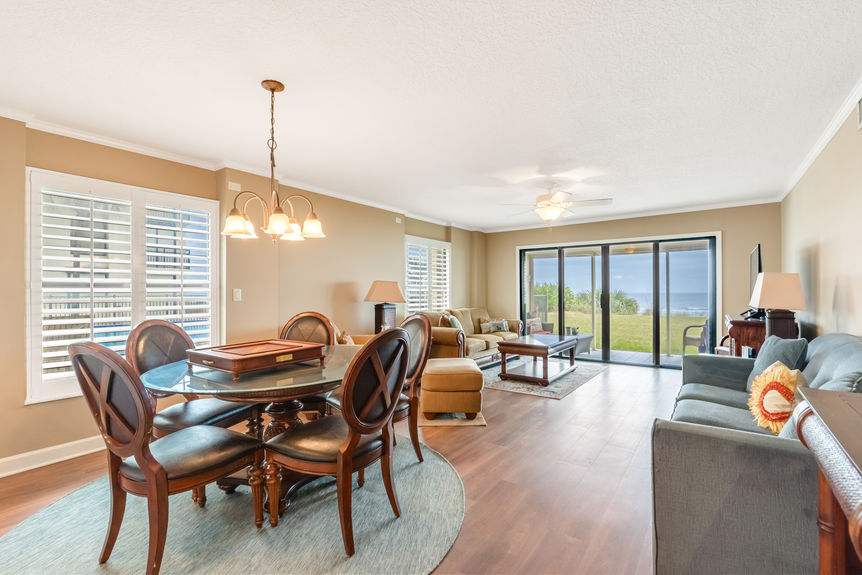Living Room View – Spacious oceanfront living room with floor-to-ceiling windows and a stunning view of St. Augustine Beach.