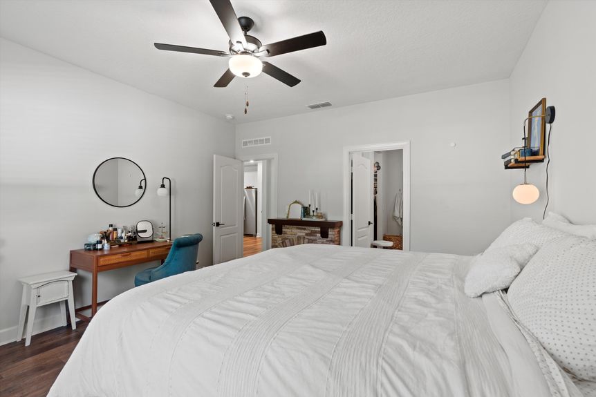 Spacious primary bedroom with large windows, neutral tones, and an ensuite bathroom in a Morgan Cove home.