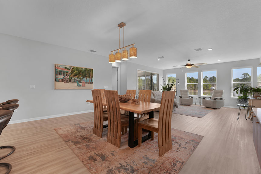 Elegant dining area with modern lighting, large windows, and an open-concept design at 50 Skyline Lane.