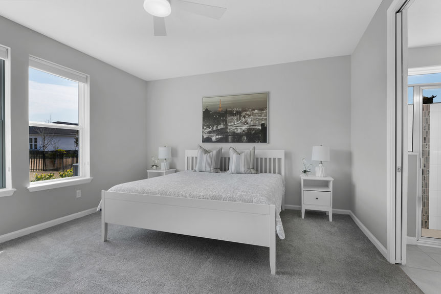 Bright and airy guest bedroom with neutral tones, large windows, and a private ensuite bath at 50 Skyline Lane.