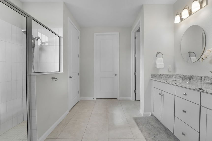 Elegant primary bathroom featuring dual vanities, a large walk-in shower, and modern fixtures at 50 Skyline Lane.