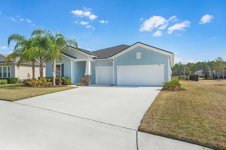 Beautiful one-story home at 50 Skyline Lane in St. Augustine’s 55+ community, featuring a well-manicured lawn, inviting front porch, and modern architectural design.
