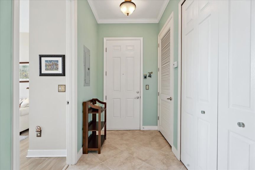 Bright and welcoming entryway in a St. Augustine condo, featuring stylish flooring and natural light.