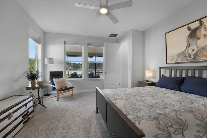 Bright and airy guest bedroom with neutral tones, large windows, and a private ensuite bath at 50 Skyline Lane.