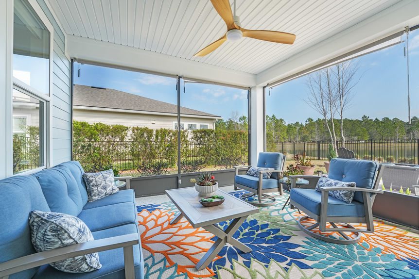 Spacious covered patio with seating area and a beautiful backyard view at 50 Skyline Lane.