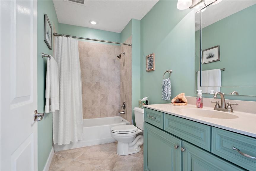 Well-designed guest bathroom featuring a sleek vanity, spacious shower, and stylish finishes.