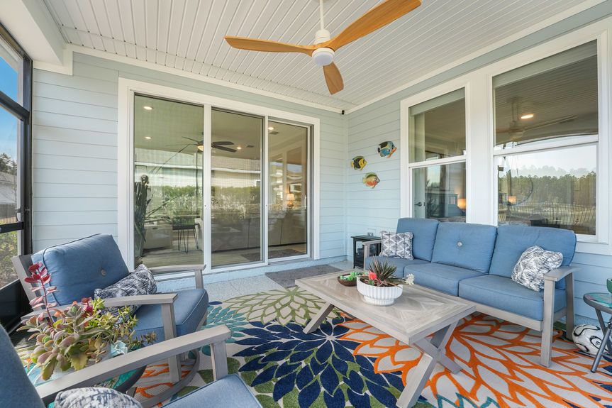 Spacious covered patio with seating area and a beautiful backyard view at 50 Skyline Lane.