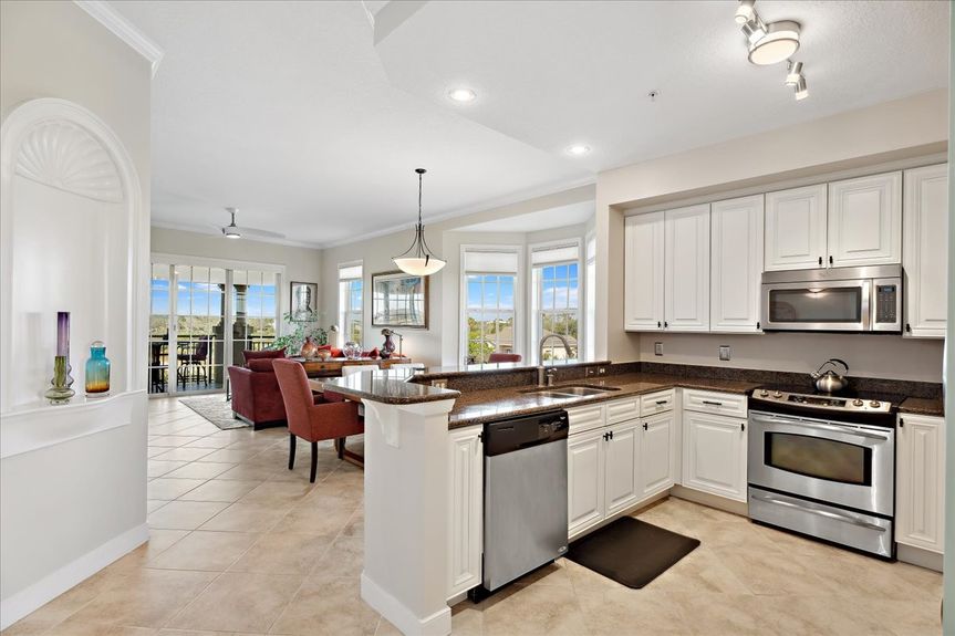 Well-equipped kitchen featuring granite countertops, ample cabinetry, and a home water filtration system.