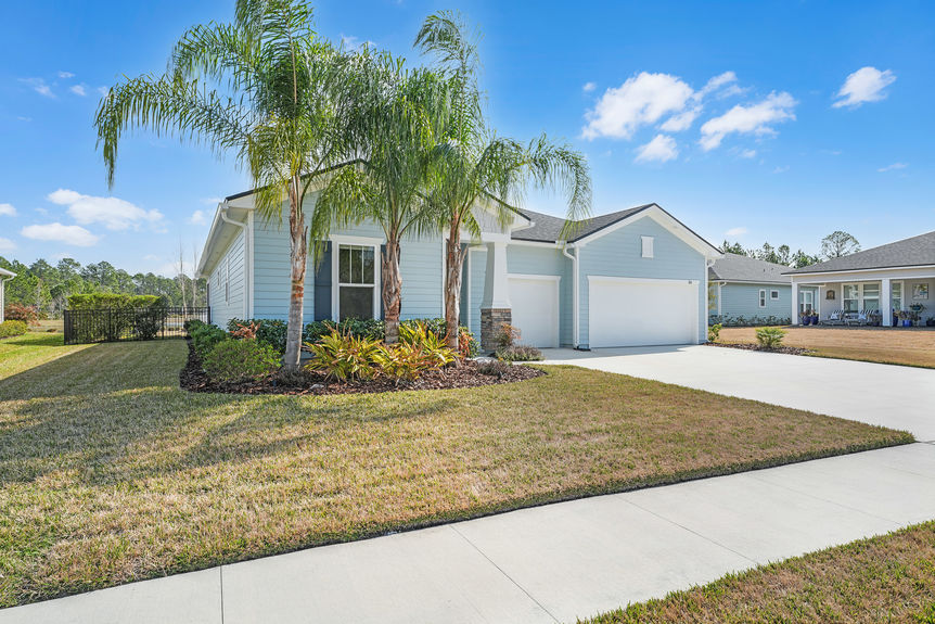 Beautiful one-story home at 50 Skyline Lane in St. Augustine’s 55+ community, featuring a well-manicured lawn, inviting front porch, and modern architectural design.