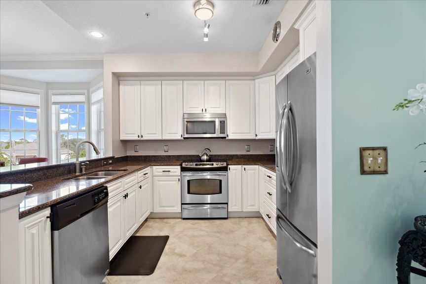 Well-equipped kitchen featuring granite countertops, ample cabinetry, and a home water filtration system.