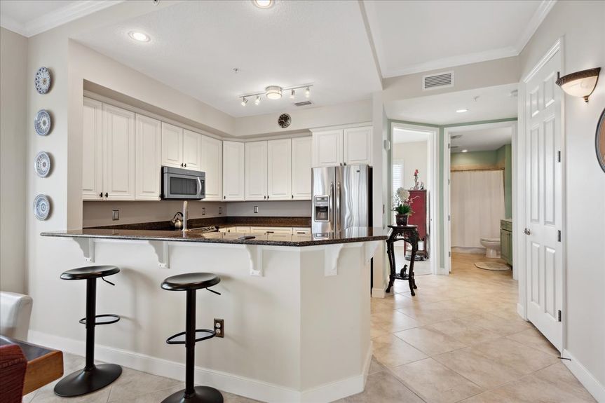 Well-equipped kitchen featuring granite countertops, ample cabinetry, and a home water filtration system.