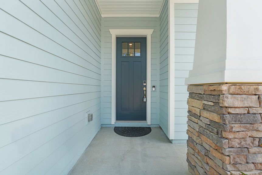 Beautiful one-story home at 50 Skyline Lane in St. Augustine’s 55+ community, featuring a well-manicured lawn, inviting front porch, and modern architectural design.