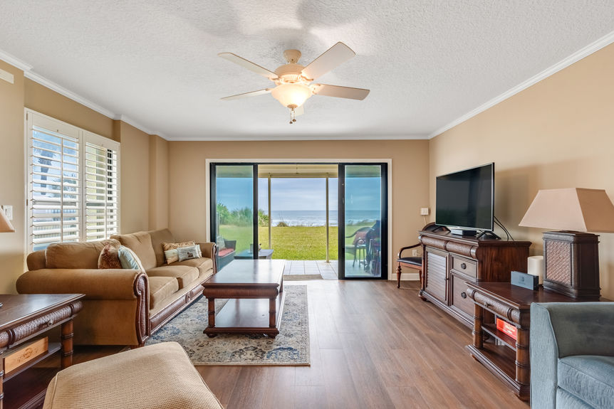 Living Room View – Spacious oceanfront living room with floor-to-ceiling windows and a stunning view of St. Augustine Beach.