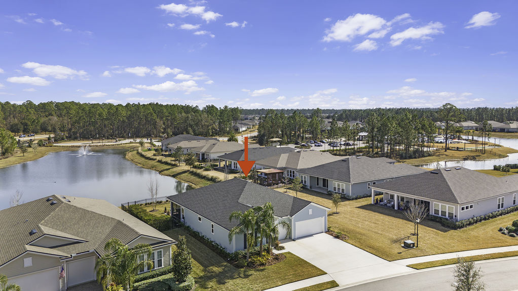 Aerial view of 50 Skyline Lane, showcasing its beautiful landscaping, spacious lot, and prime location in the 55+ community of Reverie at Trailmark, St. Augustine.
