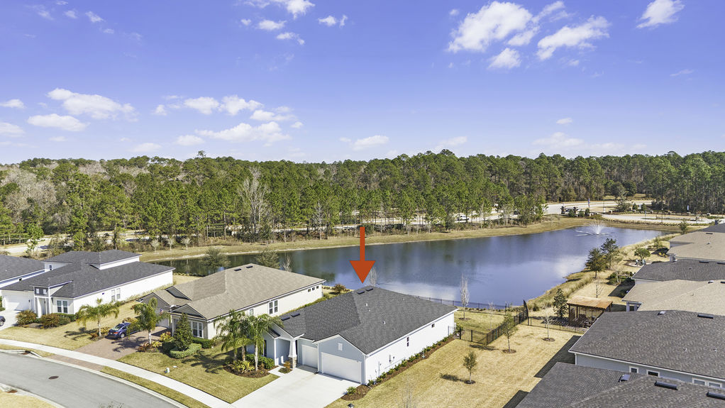 Aerial view of 50 Skyline Lane, showcasing its beautiful landscaping, spacious lot, and prime location in the 55+ community of Reverie at Trailmark, St. Augustine.