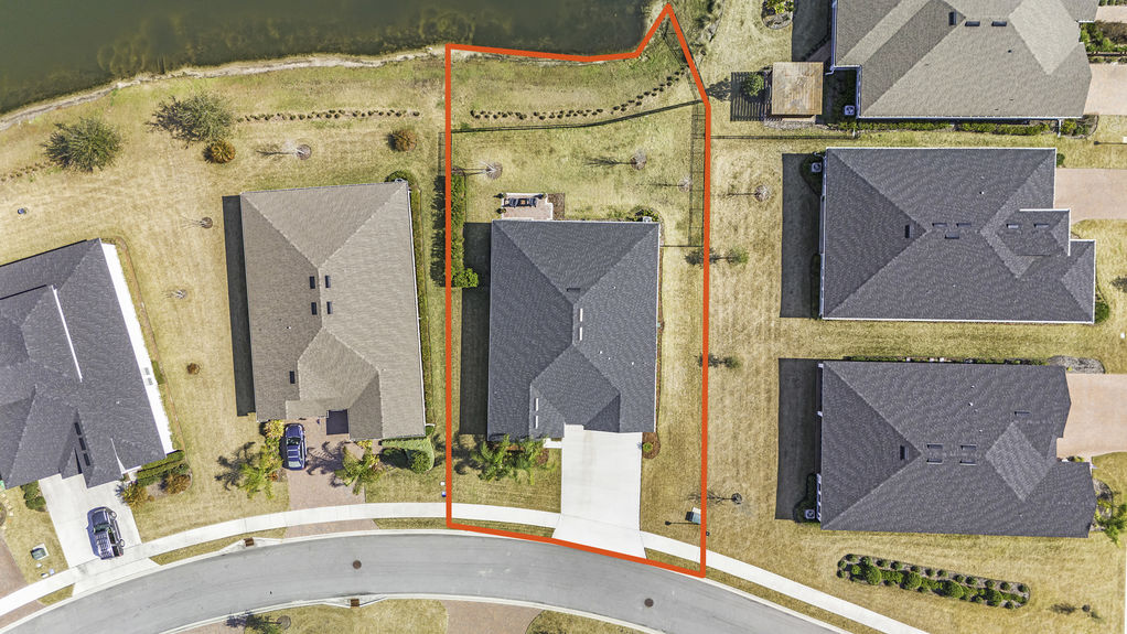 Aerial view of 50 Skyline Lane, showcasing its beautiful landscaping, spacious lot, and prime location in the 55+ community of Reverie at Trailmark, St. Augustine.