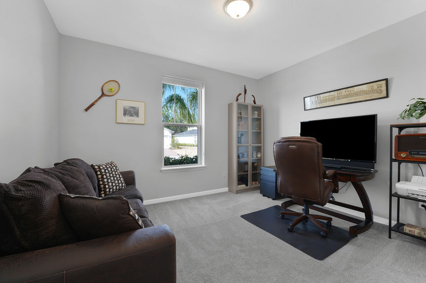 Bright and airy guest bedroom with neutral tones, large windows, and a private ensuite bath at 50 Skyline Lane.