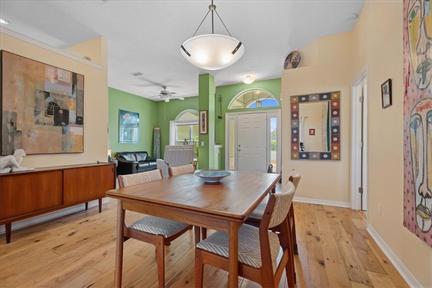 Stylish dining room at 192 Anastasia Lakes Drive, featuring an open layout, natural light, and seamless flow to the kitchen and living areas.